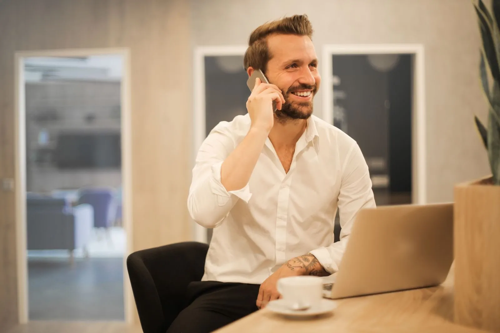 A smiling advisor on the phone with a client