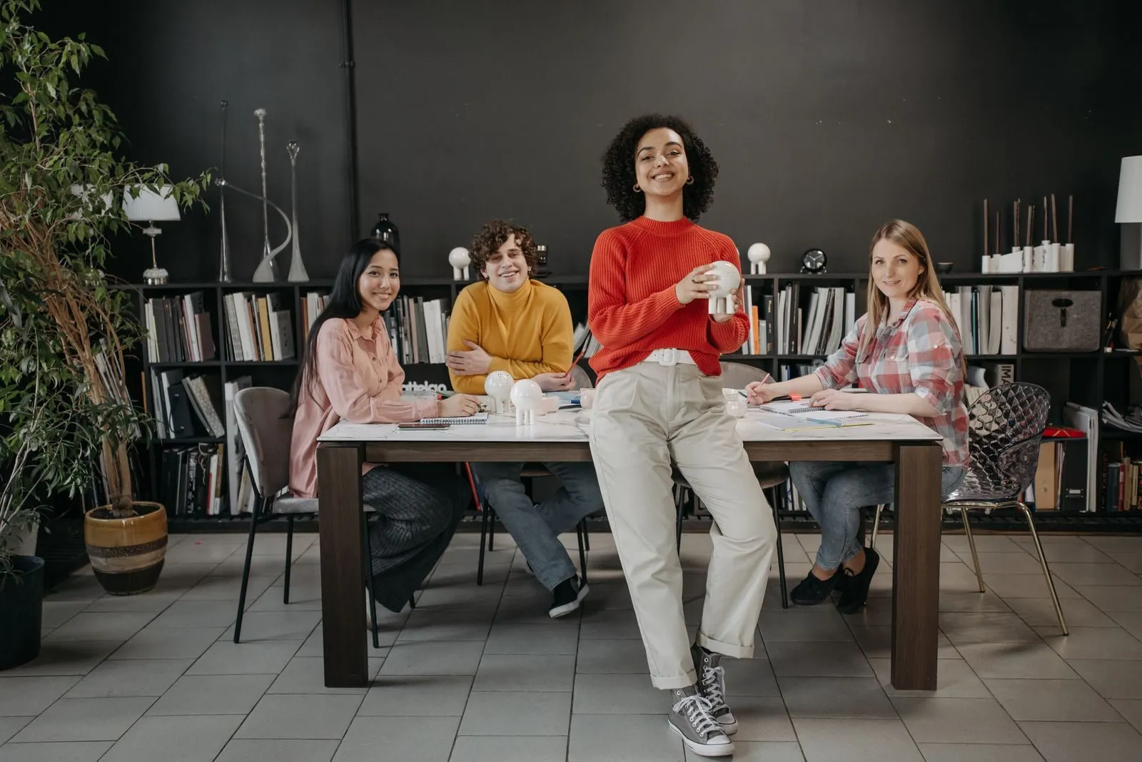 A small team smiling around a meeting table